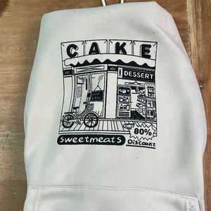 Cream colored hodded drawstring sweatshirt